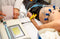 A healthcare technician monitors a male patient who is hooked up to an electrocardiogram machine.